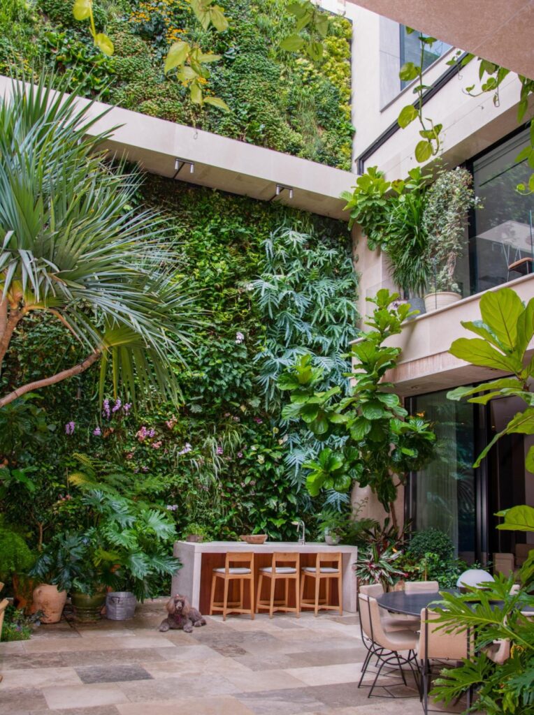 The indoor living wall transitions into the outdoor facade
